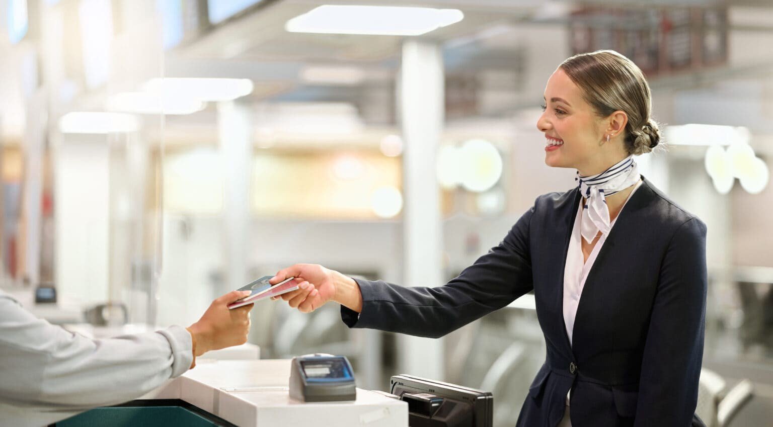 Illustrative image of an airport staff member handing a document to a traveler