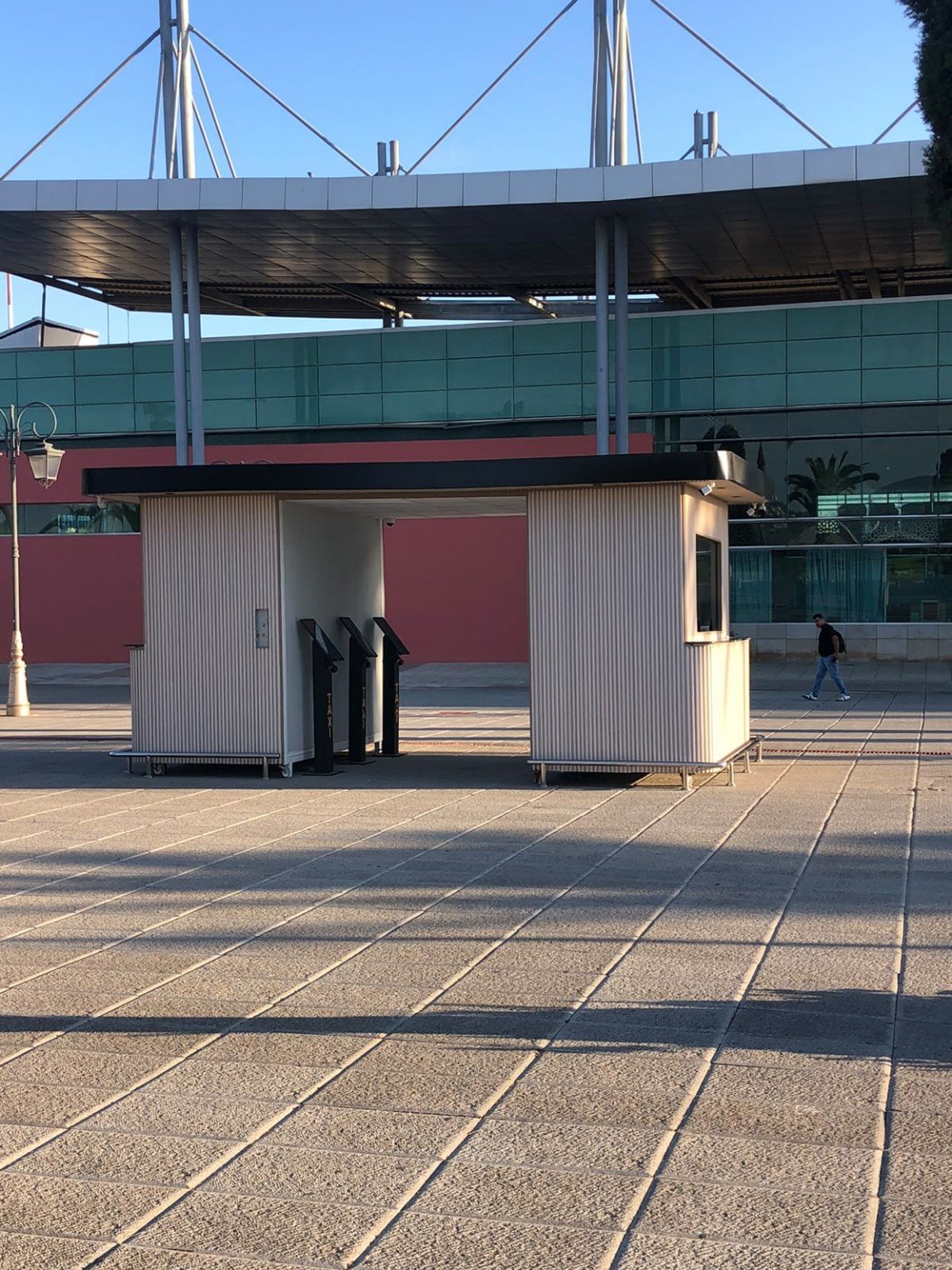 Unbranded outdoor kiosk and terminals in front of Tangier Airport; not confirmed as an AeroBus ticket office